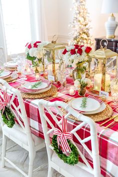 a table set for christmas dinner with red and white decor