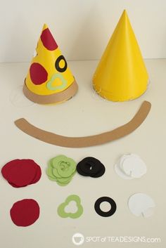 a paper hat and other crafting supplies laid out on a table