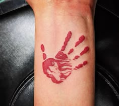 a hand print on the wrist with red ink that looks like it has been painted