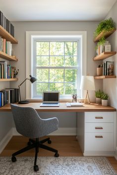 a desk with a laptop on it in front of a window and bookshelves