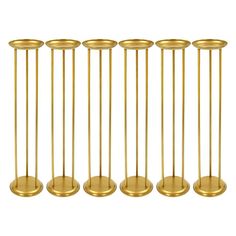 six brass candlesticks in different sizes and shapes, all lined up against each other