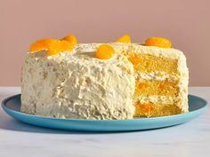 a cake with white frosting and orange candies on top is sitting on a blue plate