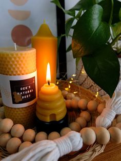 a candle sitting on top of a table next to eggs