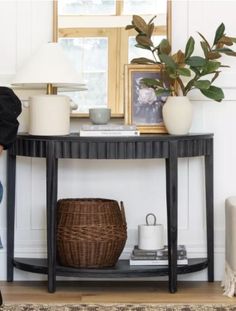 a woman sitting on a chair in front of a table with a basket underneath it