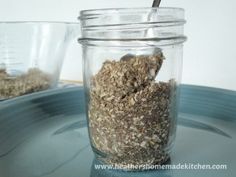 a glass jar filled with granola on top of a table