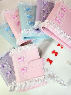 there are many different colored cases with bows on the covers and laces around them