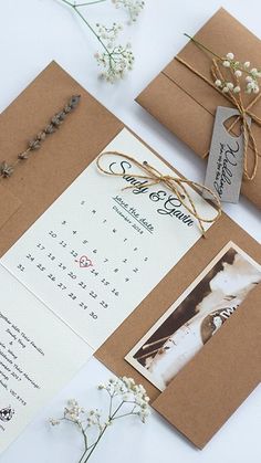 wedding stationery and envelopes with flowers on the side, tied in twine