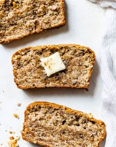 three slices of banana bread with butter on top and one slice cut off from the side