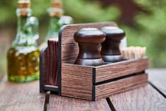 a close up of a wooden table with two bottles and a judge's block