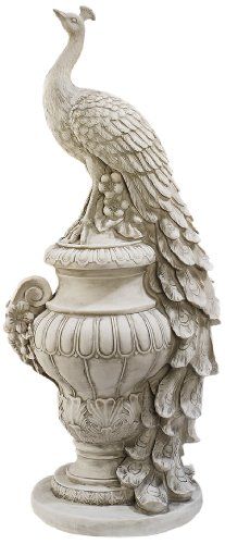 a statue of a bird sitting on top of a vase