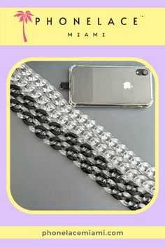 the phone case is made out of silver and black chains, with an iphone in the background