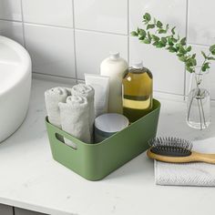 a bathroom counter with soap, toothbrush and lotion