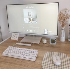 a computer monitor sitting on top of a wooden desk next to a keyboard and mouse