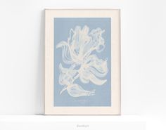 a blue and white art print on a wall