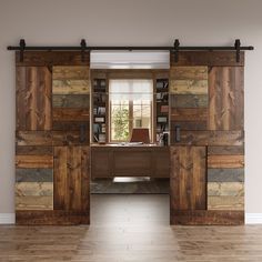 an empty room with wood paneling and sliding doors leading to a desk in the center