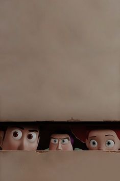 three cartoon heads are peeking out from behind a shelf