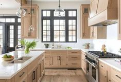 a kitchen filled with lots of wooden cabinets and white counter tops next to a stove top oven