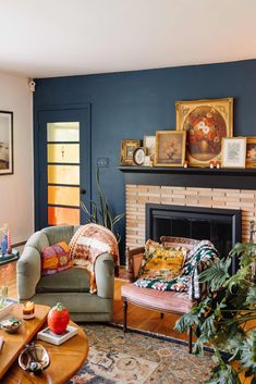 a living room filled with furniture and a fire place under a painting on the wall