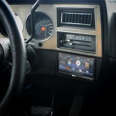 the dashboard of a car with an ipod and steering wheel