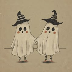 two halloween ghostes wearing hats and scarves are facing each other with their eyes closed