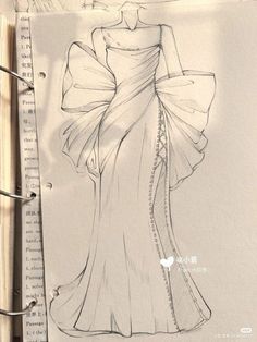 a drawing of a woman's dress on top of a piece of paper with writing underneath it