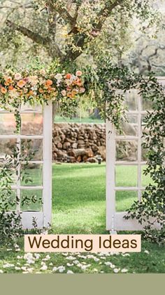 an open window with flowers and greenery on it, in front of the words wedding ideas