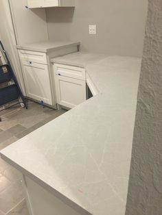 a kitchen with white cabinets and counter tops in the process of remodeling