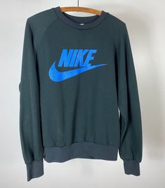 Original vintage black crewneck sweater with blue Nike graphic, circa late 80s - early 90s. Size: M Length (top of collar to bottom):  24.5" Width (pit to pit):  22.5" N O T E || As with most vintage items, they will have signs of wear. We do our best to note any noticeable flaws either in the descriptions or the photos. Please message us with any questions about the condition of items before purchasing. All sales are final. 1990 Nike Sweater, Nike Vintage, Gray Label, Black Crewneck, Blue Nike, Vintage Nike, Crew Neck Sweater, Vintage Black, Sweat Shirt