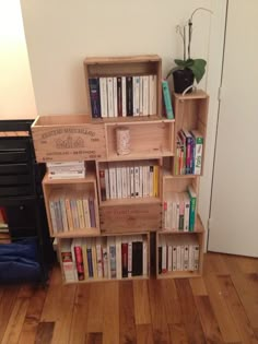 a bookshelf filled with lots of books on top of a hard wood floor