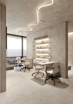 an office with two desks and chairs in front of a wall mounted bookcase