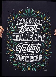 a person holding up a poster with the words hard work beats talent when talent doesn't work hard