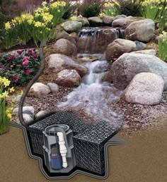 an image of a garden with rocks and water coming out of the hole in the ground