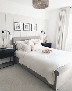 a bed with white sheets and pillows in a bedroom