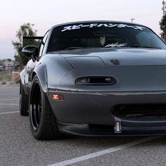 a silver sports car parked in a parking lot