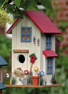 two bird houses are shown in front of some trees