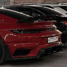 two cars parked next to each other in a garage