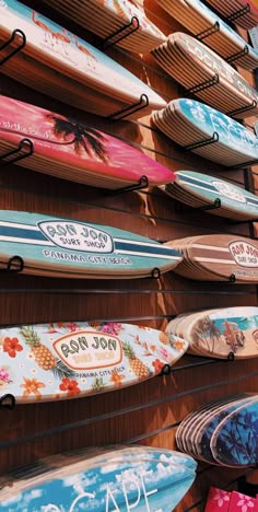 many surfboards are lined up on the wall