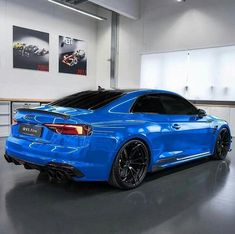 a blue sports car parked in a garage