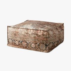 a large ottoman sitting on top of a white floor