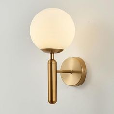 a light that is on the side of a wall with a white ball hanging from it