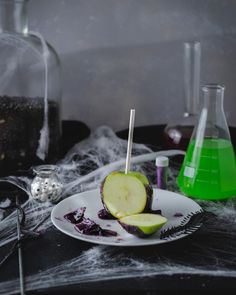 a white plate topped with an apple covered in liquid