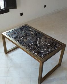 a coffee table with intricate designs on it in an empty room next to a window