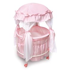 a pink baby crib with a canopy over it