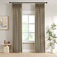 a living room with a large window covered in curtains and a rug on the floor