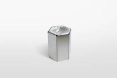 a small silver object sitting on top of a white surface