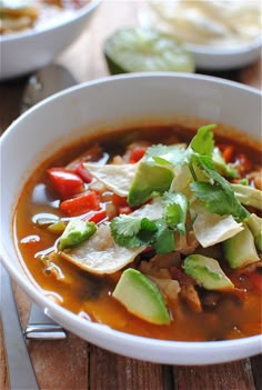 a white bowl filled with soup and vegetables