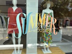 two mannequins in front of a store window with the word summer on it