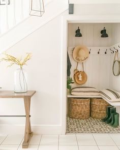 an instagram photo of a white room with some items on the wall and stairs