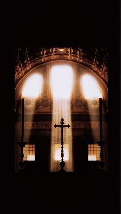 the sun shines through two windows in an old building with stained glass on it