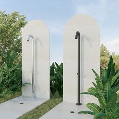 an outdoor shower in the middle of some plants and trees, with two doors open on either side